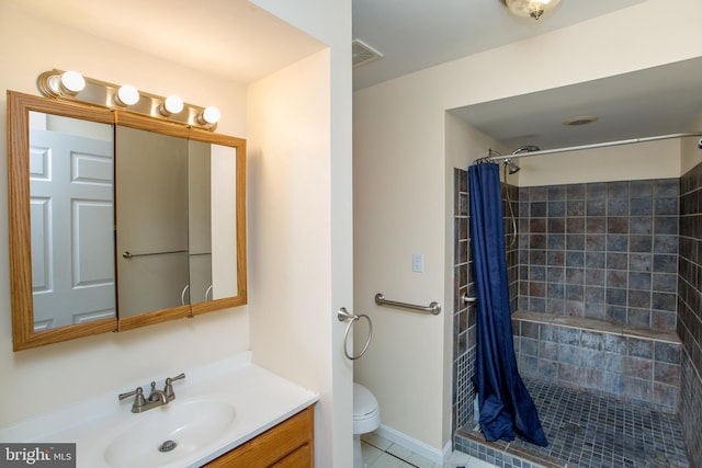 bathroom with vanity, walk in shower, tile patterned flooring, and toilet