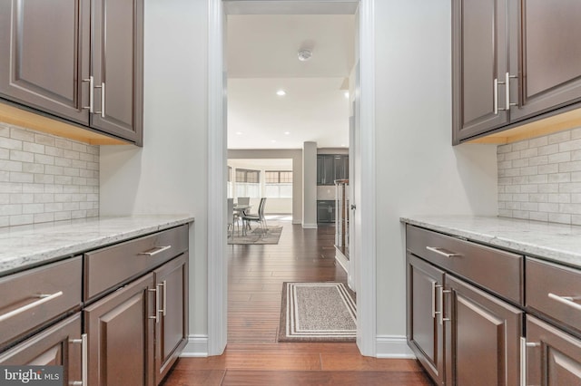 kitchen with tasteful backsplash, dark hardwood / wood-style flooring, and dark brown cabinets