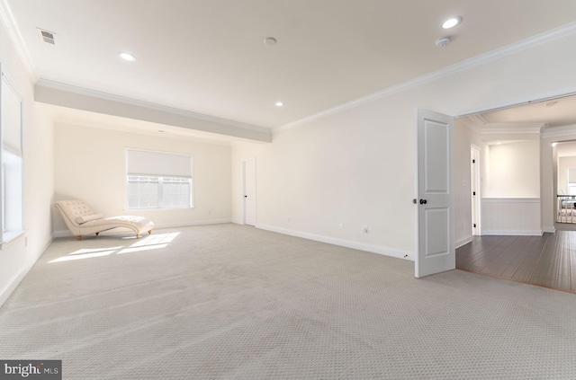 spare room featuring wood-type flooring and crown molding