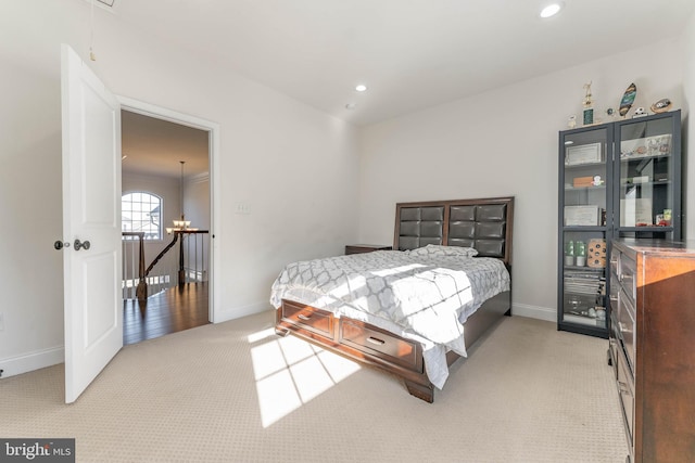 carpeted bedroom featuring an inviting chandelier