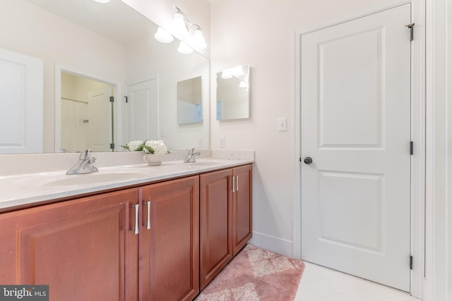 bathroom with tile patterned floors and vanity