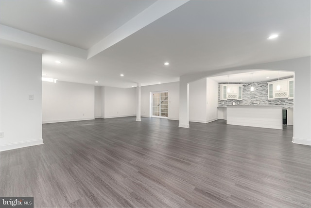 unfurnished living room featuring dark hardwood / wood-style floors