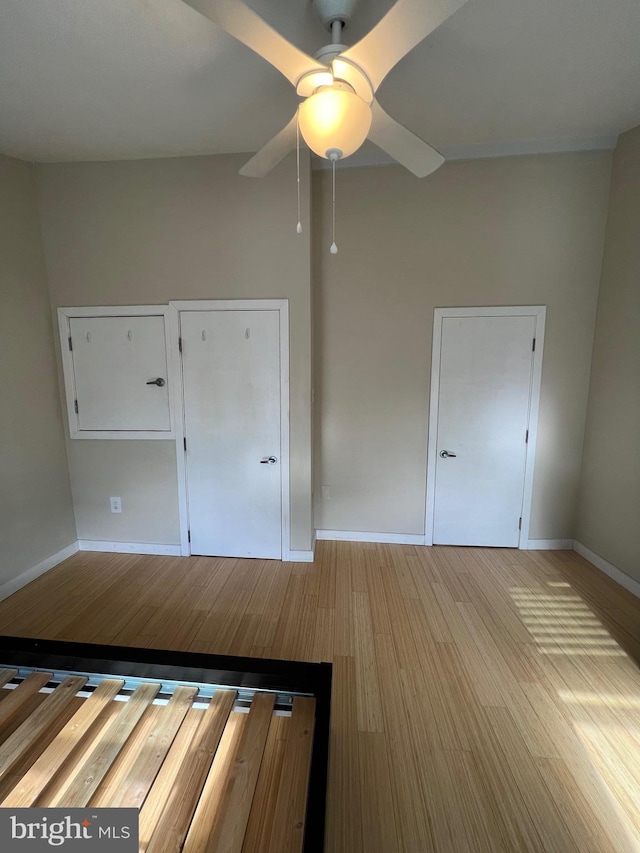 unfurnished bedroom with light wood-type flooring and ceiling fan