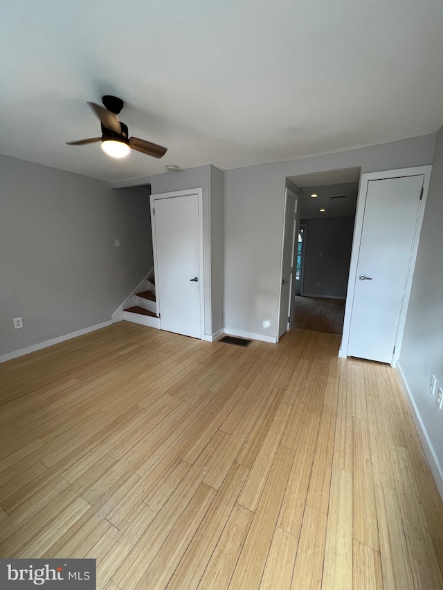 empty room featuring light wood-type flooring and ceiling fan