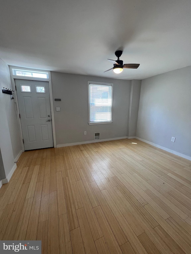 foyer with light hardwood / wood-style floors and ceiling fan