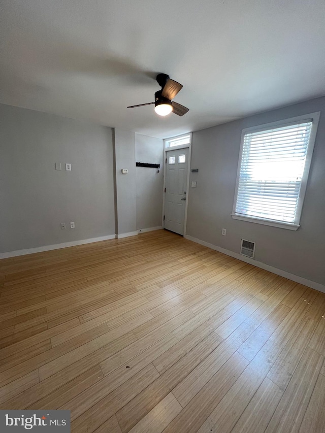 foyer with ceiling fan and light hardwood / wood-style floors