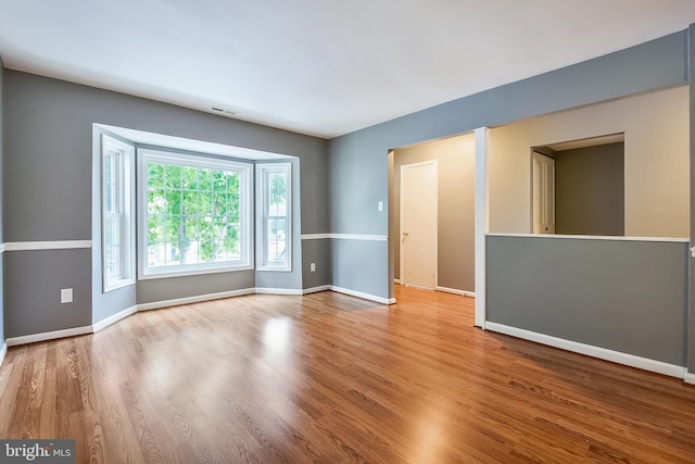 unfurnished room with light hardwood / wood-style flooring