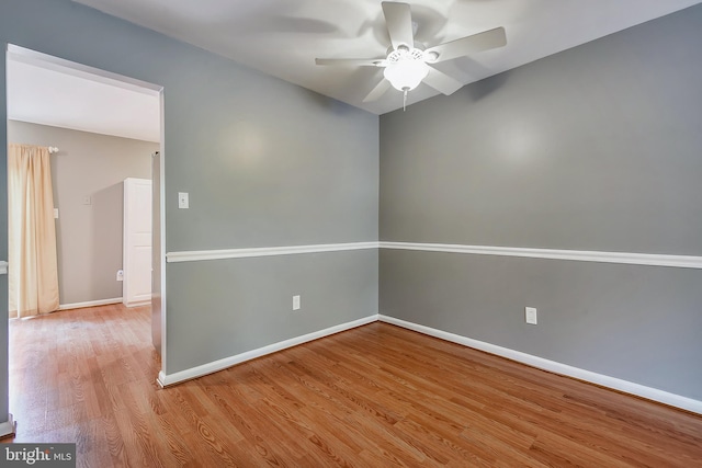 empty room with ceiling fan and light hardwood / wood-style flooring