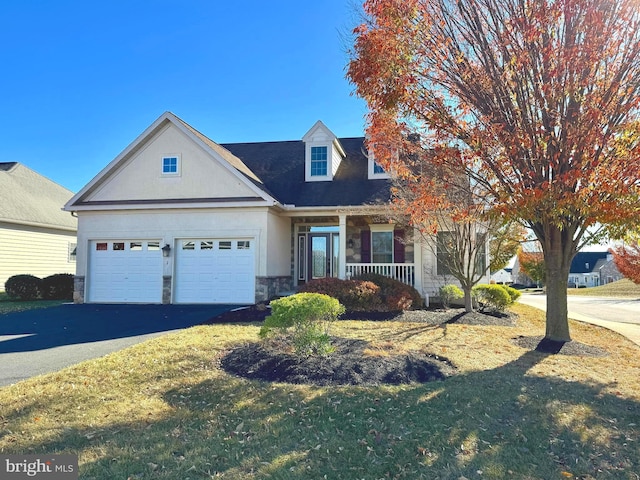 view of front of home with a garage and a front yard