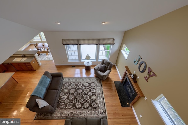 living room featuring light hardwood / wood-style floors and lofted ceiling