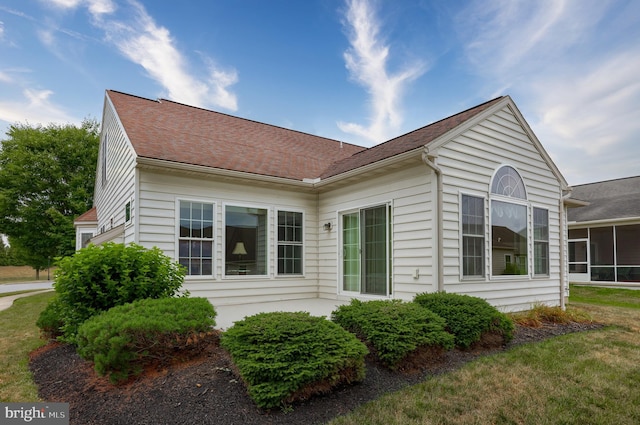 view of side of home with a sunroom