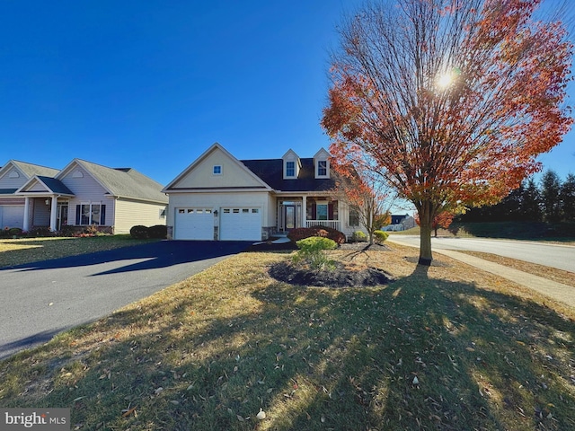 view of front of house with a garage and a front lawn