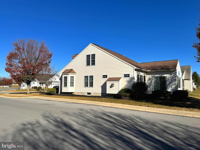 view of side of home featuring a yard