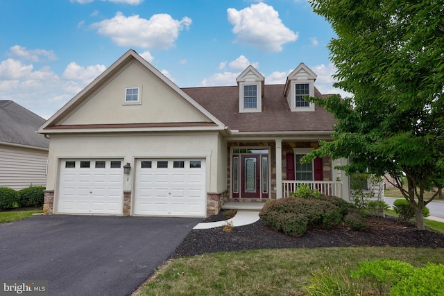 view of front of property with a garage and covered porch