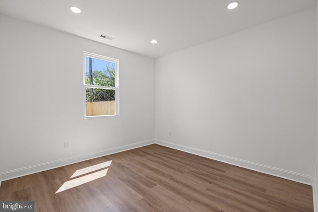 unfurnished room with hardwood / wood-style floors