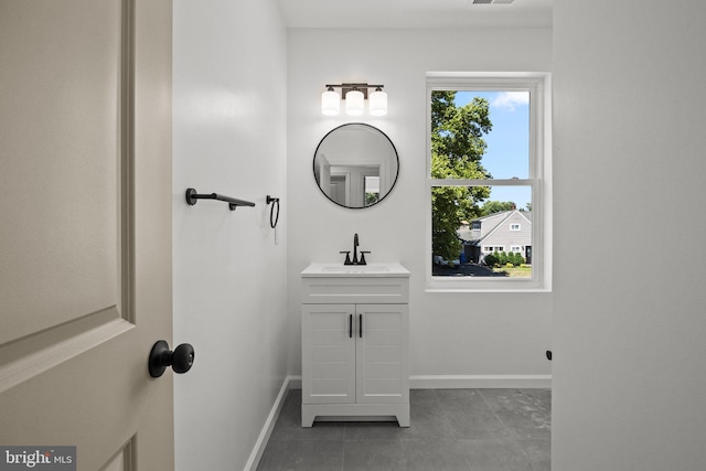 bathroom featuring tile patterned flooring and vanity