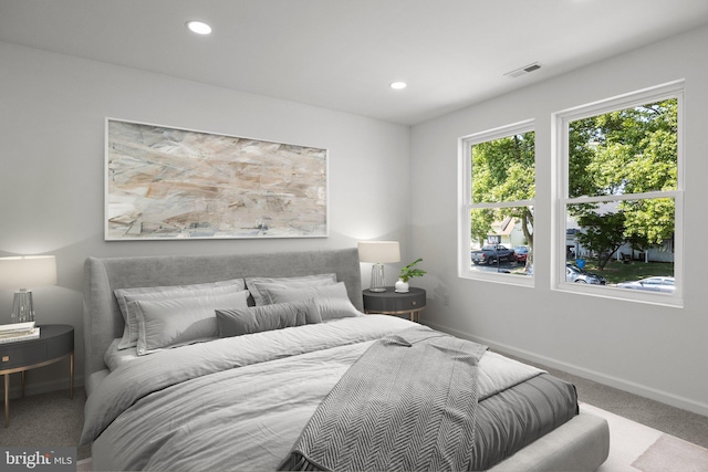 bedroom with light colored carpet