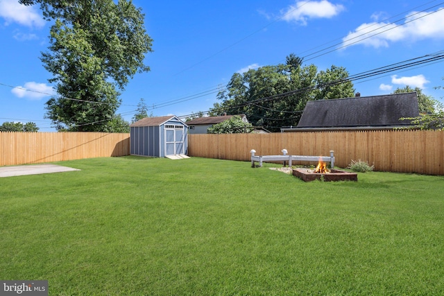 view of yard with a shed and a fire pit