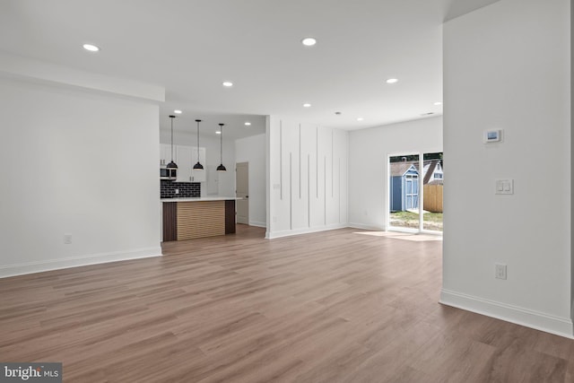 unfurnished living room with light wood-type flooring