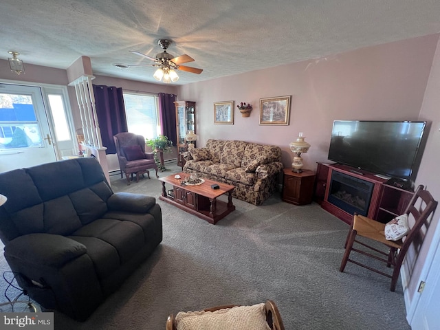 living room with carpet, ceiling fan, and a textured ceiling