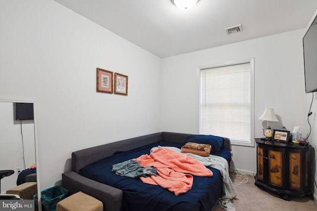 bedroom featuring light colored carpet