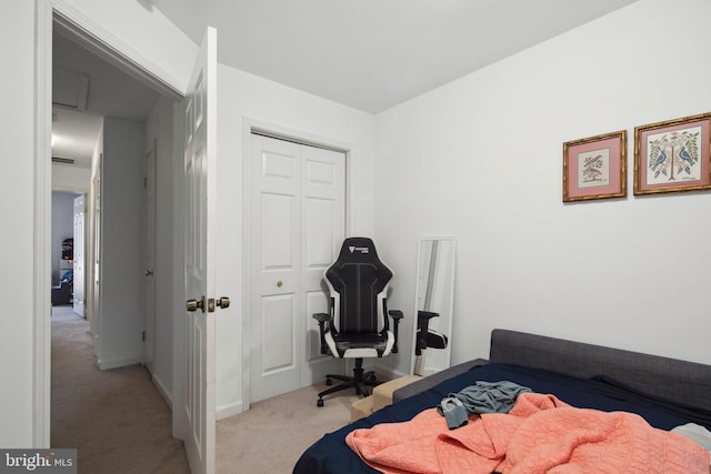 bedroom with light colored carpet and a closet