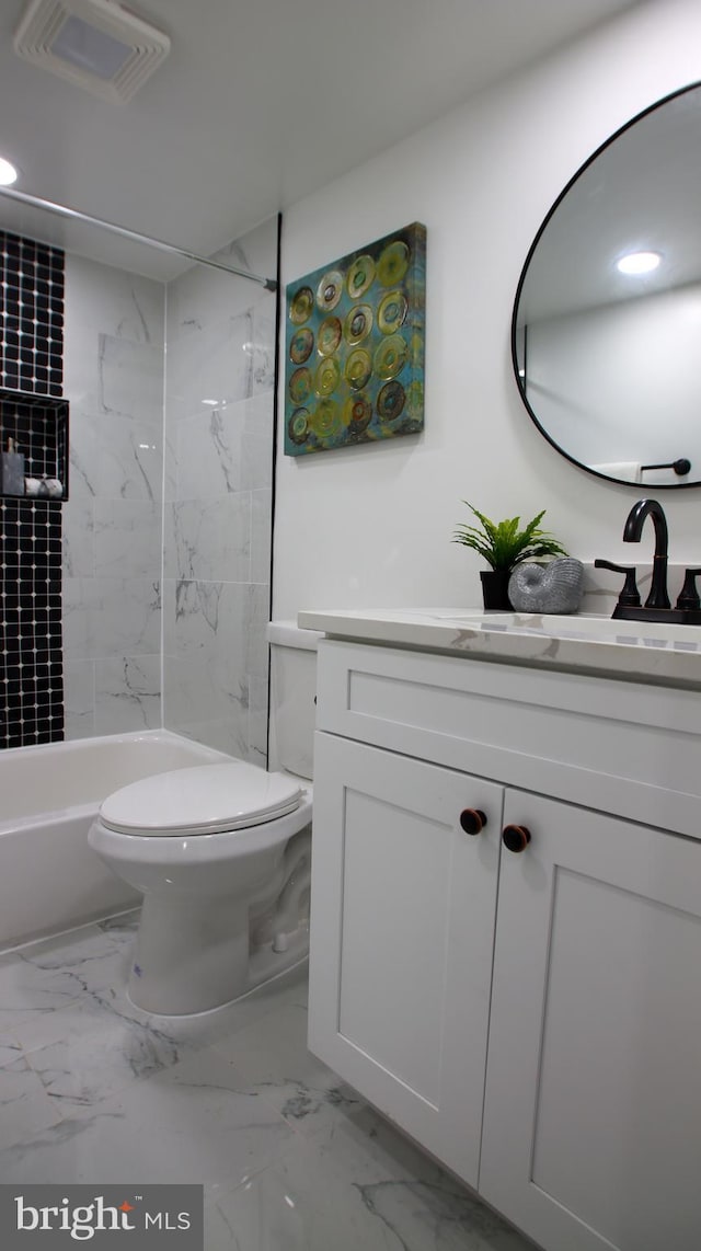 full bathroom with vanity, toilet, and tiled shower / bath