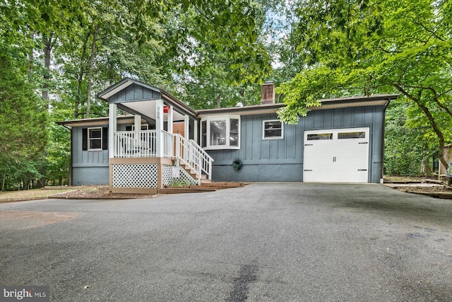 view of front of property featuring a garage and a porch