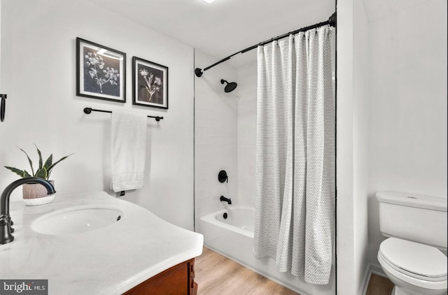 full bathroom with shower / bath combo with shower curtain, vanity, hardwood / wood-style flooring, and toilet