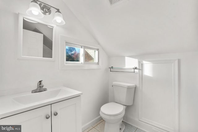 bathroom featuring toilet, vanity, lofted ceiling, and tile patterned flooring