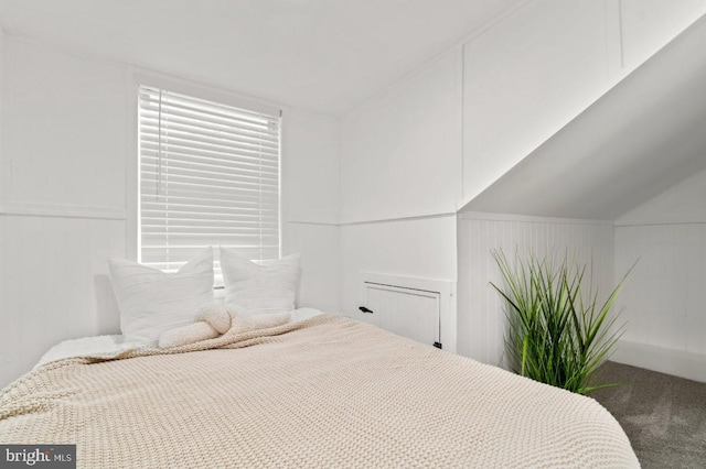 carpeted bedroom with vaulted ceiling