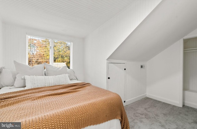 carpeted bedroom featuring lofted ceiling