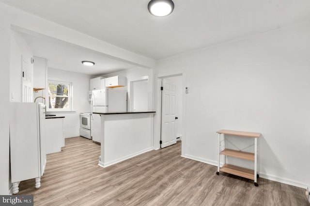 kitchen featuring white appliances, light hardwood / wood-style floors, and white cabinets