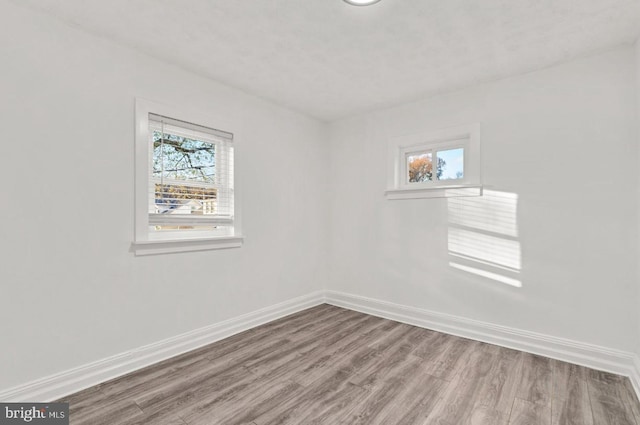 empty room featuring hardwood / wood-style floors and plenty of natural light