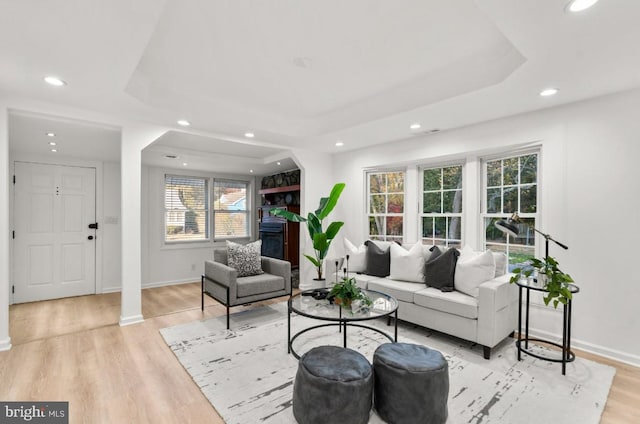 living room featuring ornate columns and light hardwood / wood-style floors