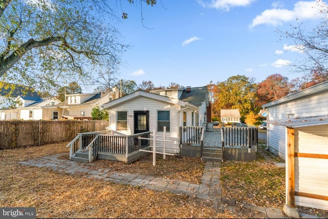 rear view of house featuring a deck