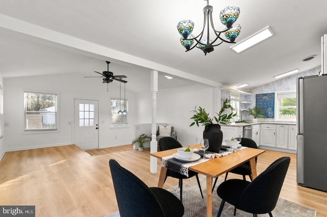 dining space with light hardwood / wood-style flooring and lofted ceiling