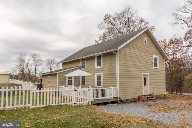 view of side of property with a lawn and a deck