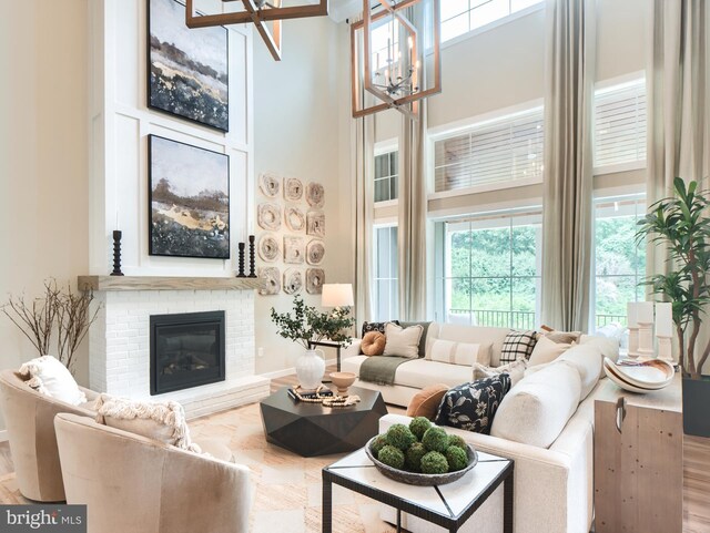 0707007728 Hook Rd Nottingham, Unit Nottingham, Westminster, MD 21157 - living area featuring a high ceiling, a chandelier, a fireplace, and baseboards