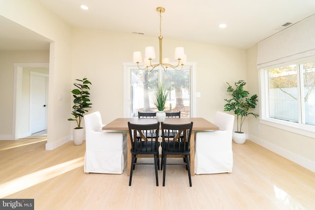 dining area featuring a chandelier and light wood-type flooring