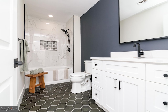 full bathroom featuring toilet, tiled shower / bath combo, vanity, and tile patterned floors