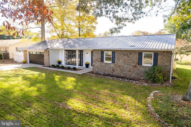 ranch-style house featuring a garage and a front yard