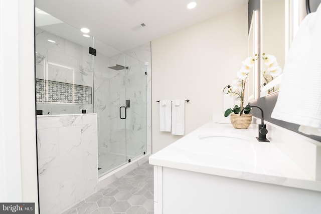 bathroom featuring walk in shower, vanity, and tile patterned flooring