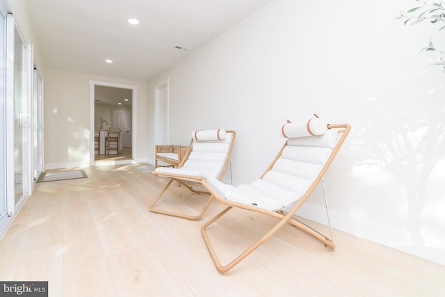 living area with light hardwood / wood-style flooring