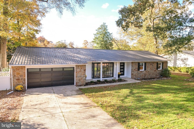 ranch-style home featuring a garage and a front yard