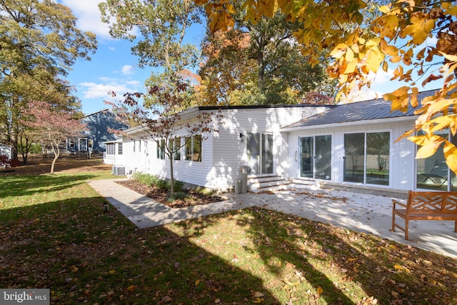 back of house featuring a yard and a patio area