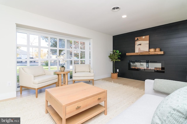 living room featuring wooden walls and hardwood / wood-style floors