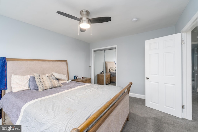 bedroom with ceiling fan, dark carpet, and a closet