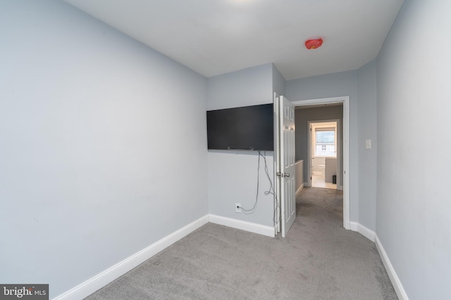 unfurnished bedroom featuring light colored carpet