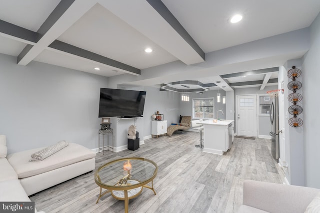 living room with beam ceiling, light wood-type flooring, coffered ceiling, and sink